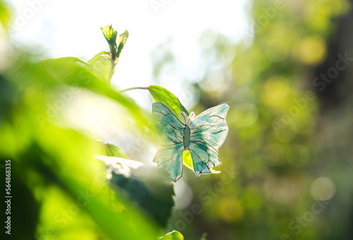 Closeup hand drawn paper butterfly in garden outdoors photo