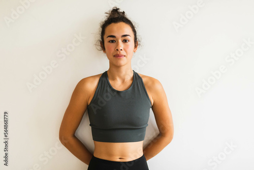 Woman in workout clothes white wall photo