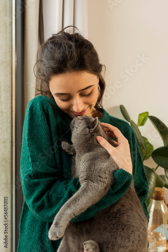 Young girl giving affection to her angora cat