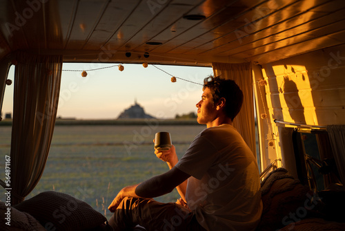 Man with coffee in camper van photo