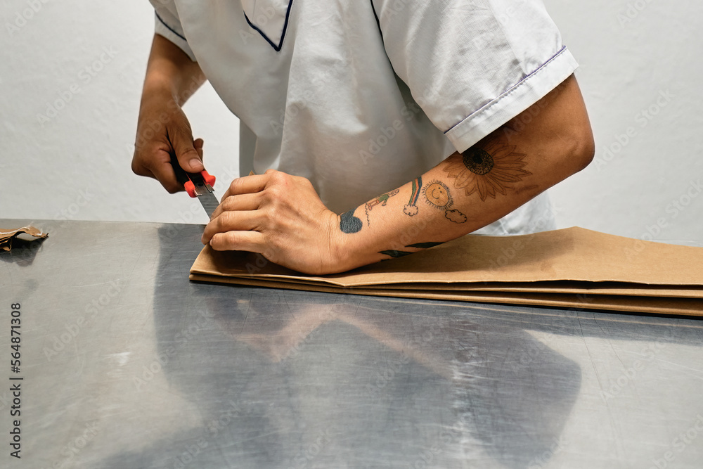 Employee cutting paper with a scalpel Stock Photo | Adobe Stock