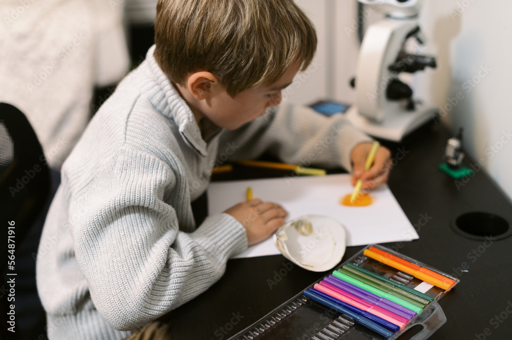 little kid drawing at his desk little kid drawing at his desk