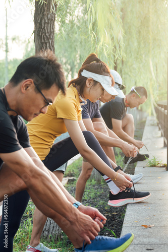 Groups of friends tying shoelaces
