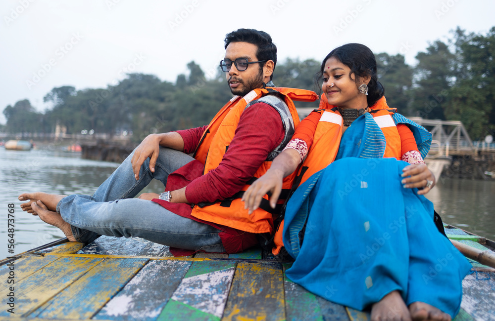 © Dream Lover/Stocksy - Young Couple Enjoying Travel Sitting On A Boat Over River Ganga,India