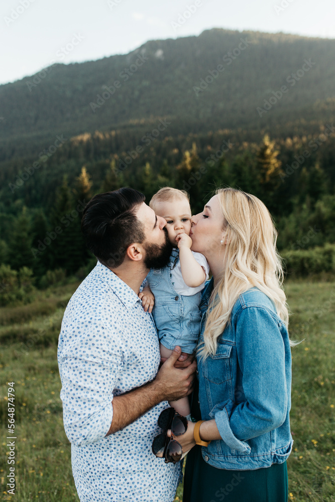 Loving family kissing their child Loving family kissing their child