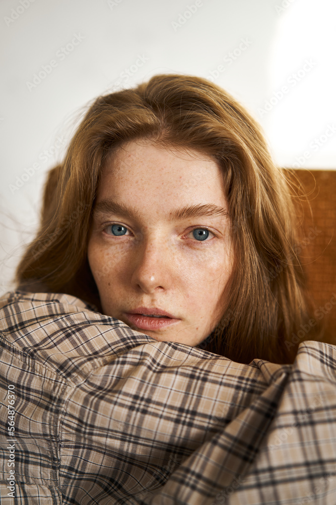 Young female in checkered shirt looking at camera Young female in checkered shirt looking at camera
