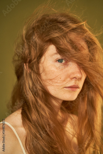 Calm woman with gray eyes and flying hair photo