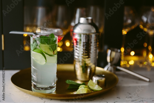 A mojito cocktail on a brass tray photo