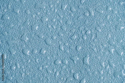 Blue abstract background, texture covered with raindrops by condensation.
