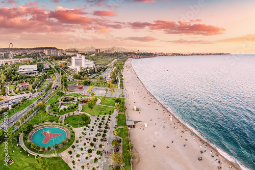 Fototapeta Naklejka Na Ścianę i Meble -  Aerial view of a beach park with vacationers in Antalya, Turkiye. Mediterranean sea coast and riviera.