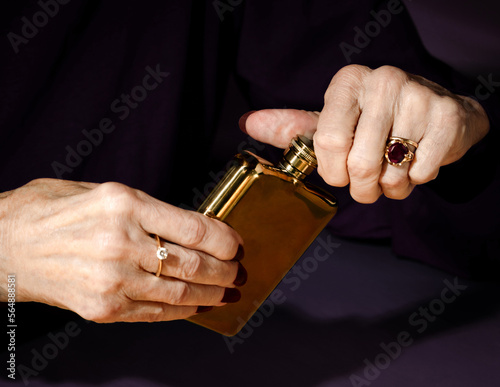 Woman Opening Hip Flask  photo