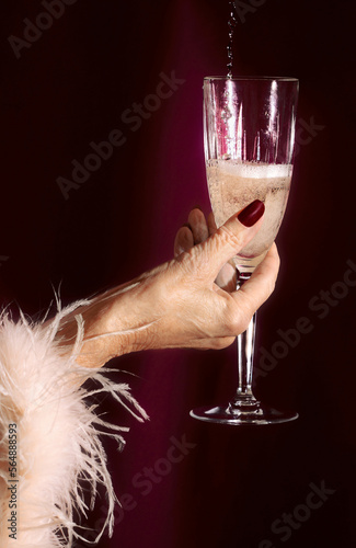 Senior Hand Holding Champagne Flute photo