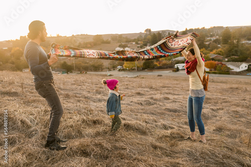 Couple folding picnic blanket at regional park photo