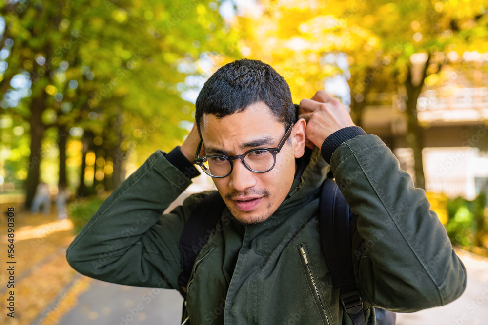 Young Adult Wearing a Parka Outdoors in Autumn Young Adult Wearing a Parka Outdoors in Autumn