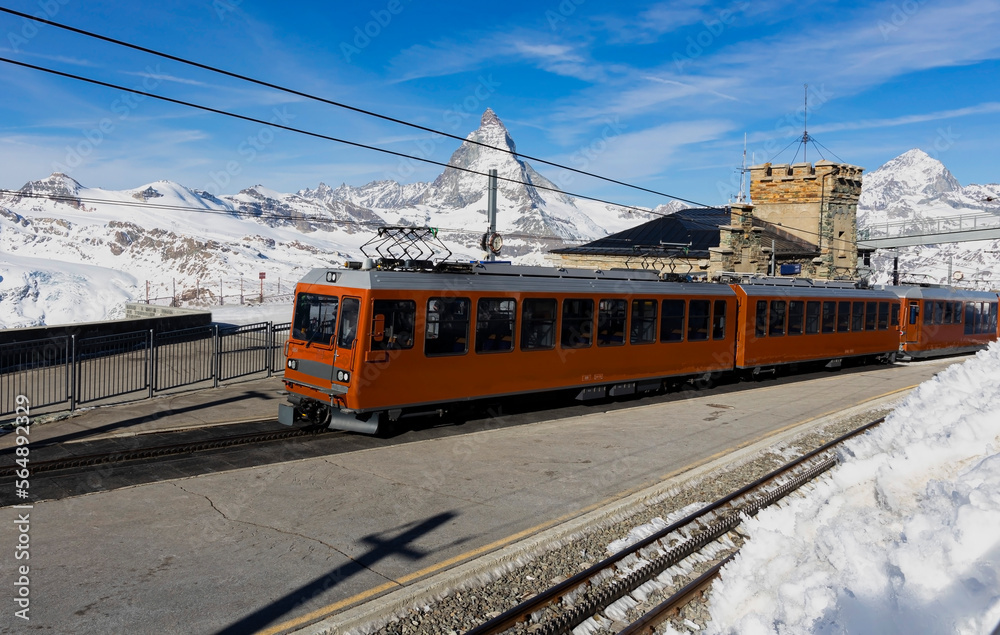 Fototapeta premium Beautiful view in Zermatt, Switzerland as rack railway and Gornergrat orange tourist trainunder breathtaking Matterhorn,Zermatt,Valais,Switzerland,Europe
