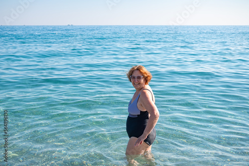 happy senior woman swimming in the sea photo