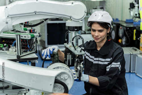 Team woman of engineers practicing maintenance Taking care and practicing maintenance of old machines in the factory so that they can be used continuously.