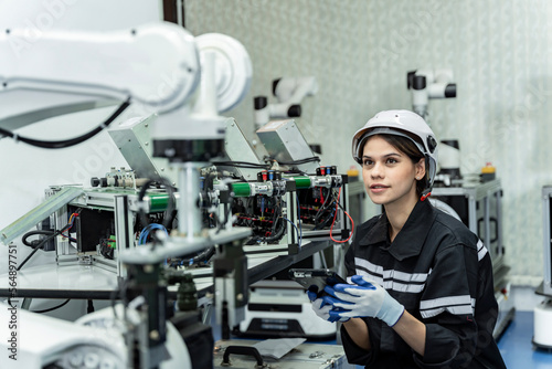 Team woman of engineers practicing maintenance Taking care and practicing maintenance of old machines in the factory so that they can be used continuously.