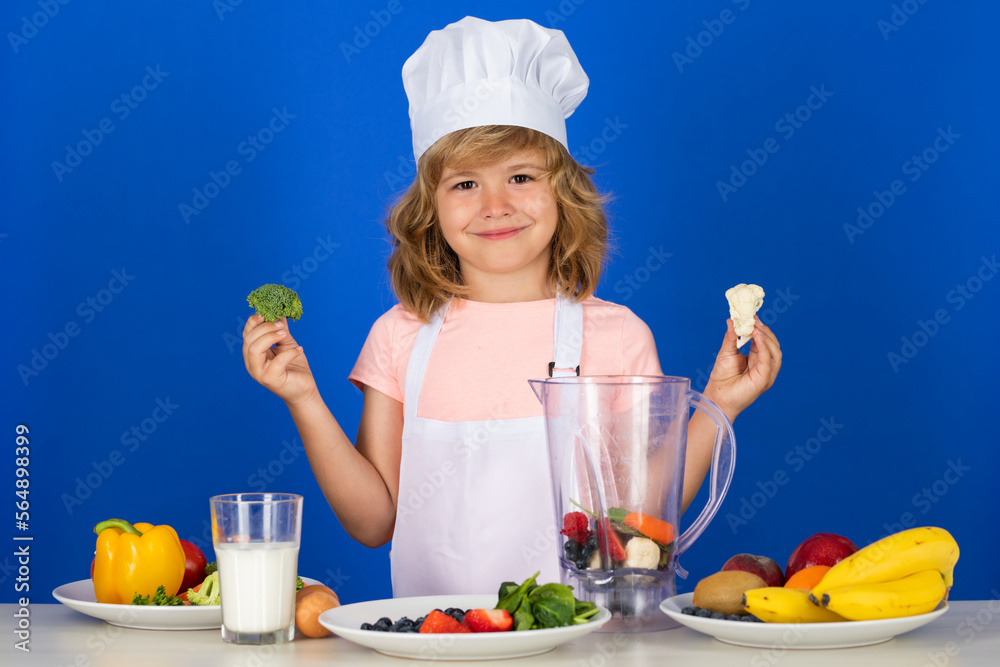 Cooking children. Chef kid boy hold broccoli making fresh vegetables for healthy eat. Portrait of little child in form of cook isolated on grey background. Kid chef. Cooking process. Cooking children. Chef kid boy hold broccoli making fresh vegetables for healthy eat. Portrait of little child in form of cook isolated on grey background. Kid chef. Cooking process.