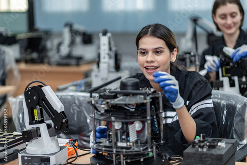 Team woman of engineers practicing maintenance Taking care and practicing maintenance of old machines in the factory so that they can be used continuously.