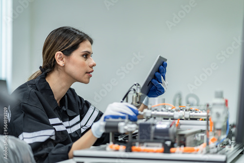 Team woman of engineers practicing maintenance Taking care and practicing maintenance of old machines in the factory so that they can be used continuously.