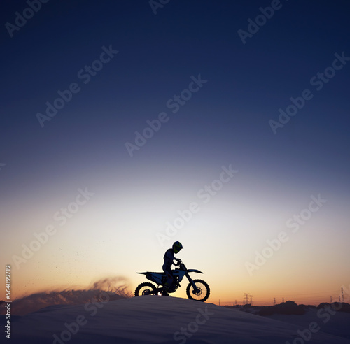 Silhouette, sport and riding motorcycle against night, sky and background in nature, extreme sports and adrenaline. Biking, motorbike and person driving on dirt road, dark and shadow, stunt and free