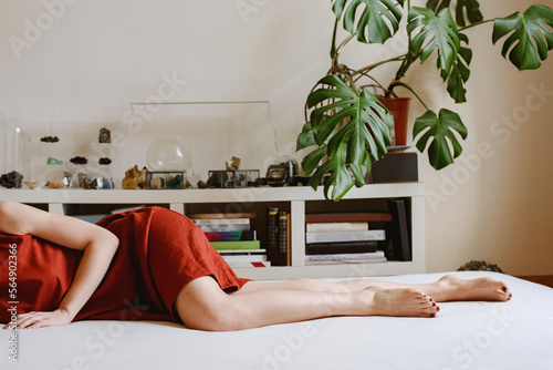 Woman lyingon a couch at home photo