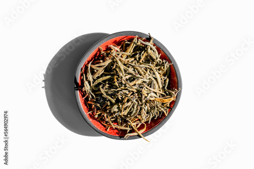 Premium white tea in a red and black bowl isolated on white background top view