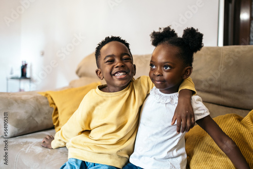 Portrait of smiling little black siblings at home photo