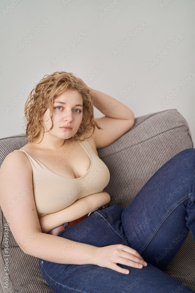 Relaxed curvy woman on sofa Relaxed curvy woman on sofa