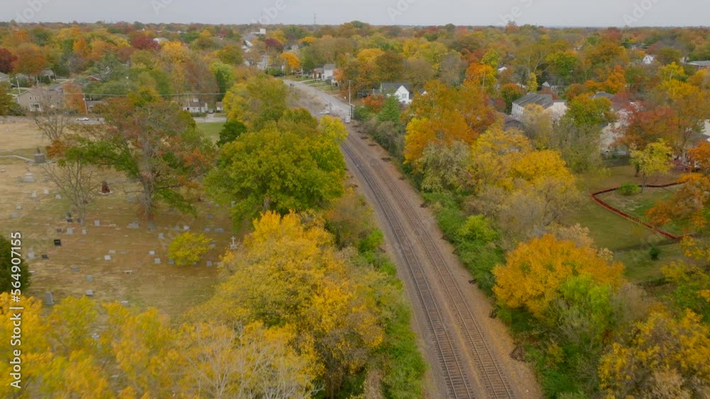 Aerial view following train tracks through Kirkwood neighborhood in Autumn at peak color. Aerial view following train tracks through Kirkwood neighborhood in Autumn at peak color.