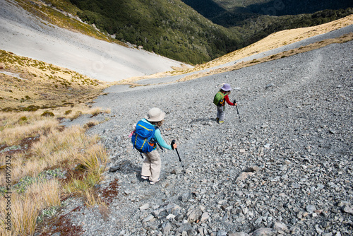 Kids traversing a scree slope, New Zealand. photo