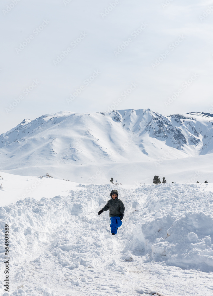 Boy running and playing through the snow Boy running and playing through the snow