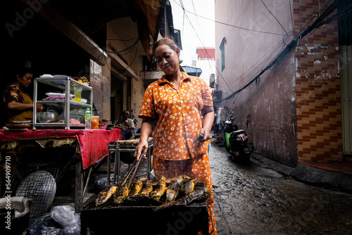Fresh catfish being grilled on the street in Cambodia photo