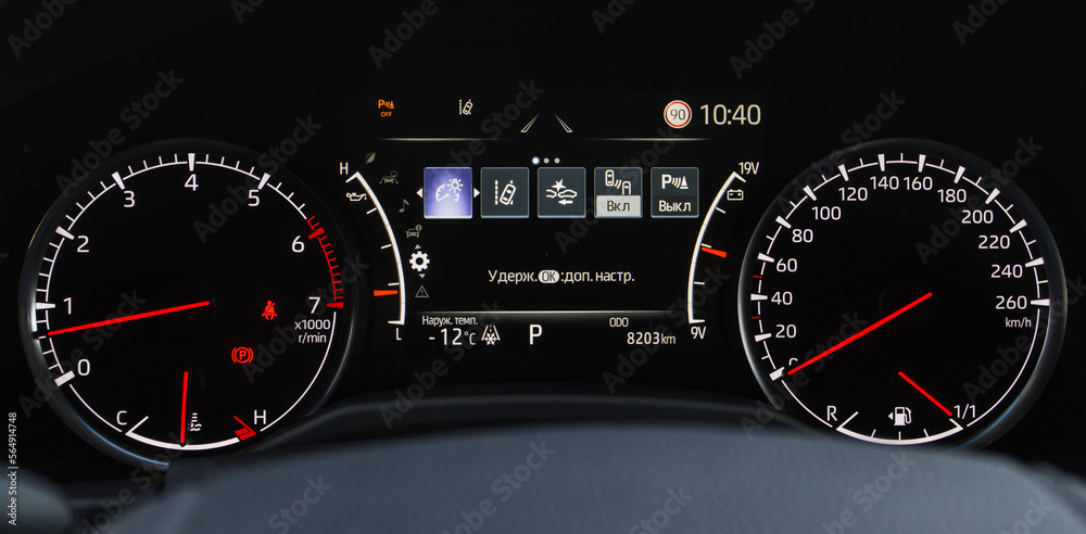 Fototapeta premium Close up shot with the digital car dashboard. Illuminated car dashboard. Translation 