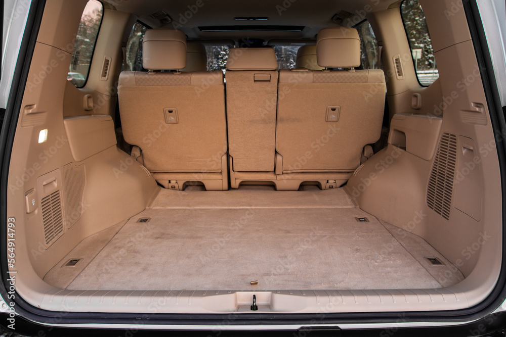 Huge, clean and empty car trunk in interior of compact suv. Rear view of a SUV car with open trunk - obrazy, fototapety, plakaty 