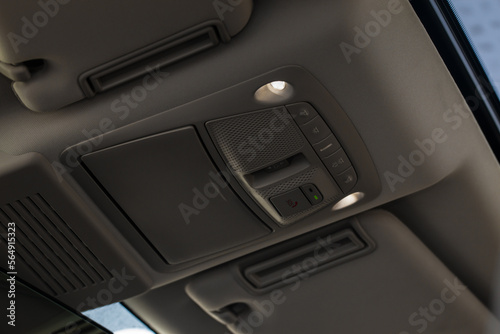 Close up image of the SOS button and car ceiling lamp in a car. © Roman