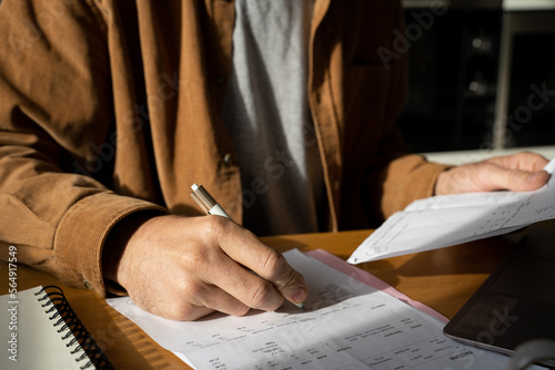 Man paying utility bills  from home  photo