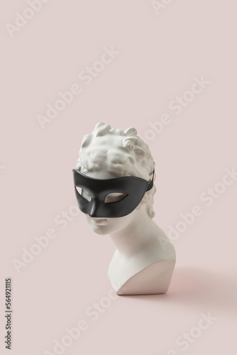 Gypsum goddess bust wearing black fetish mask. photo