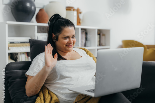 Overweight caucasian woman is talking on the video call