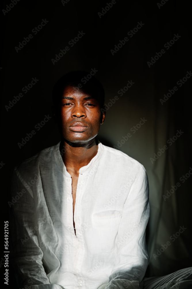 Man with his face illuminated by sunlight at daytime. Man with his face illuminated by sunlight at daytime.