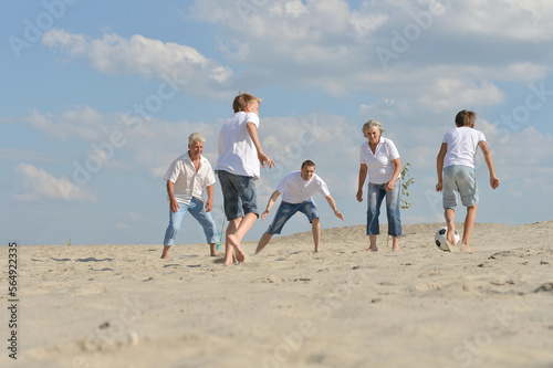 Family playing football on a beach in summer day © aletia2011
