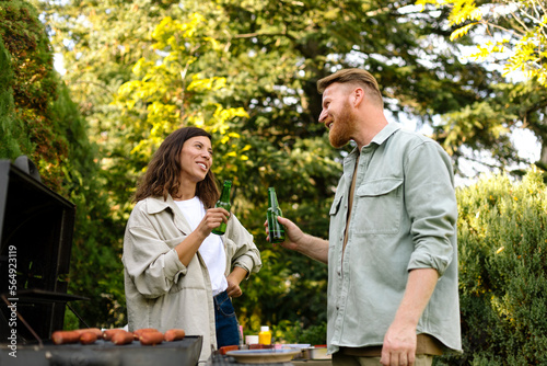 Man and Woman Toasting at Barbecue Party  photo