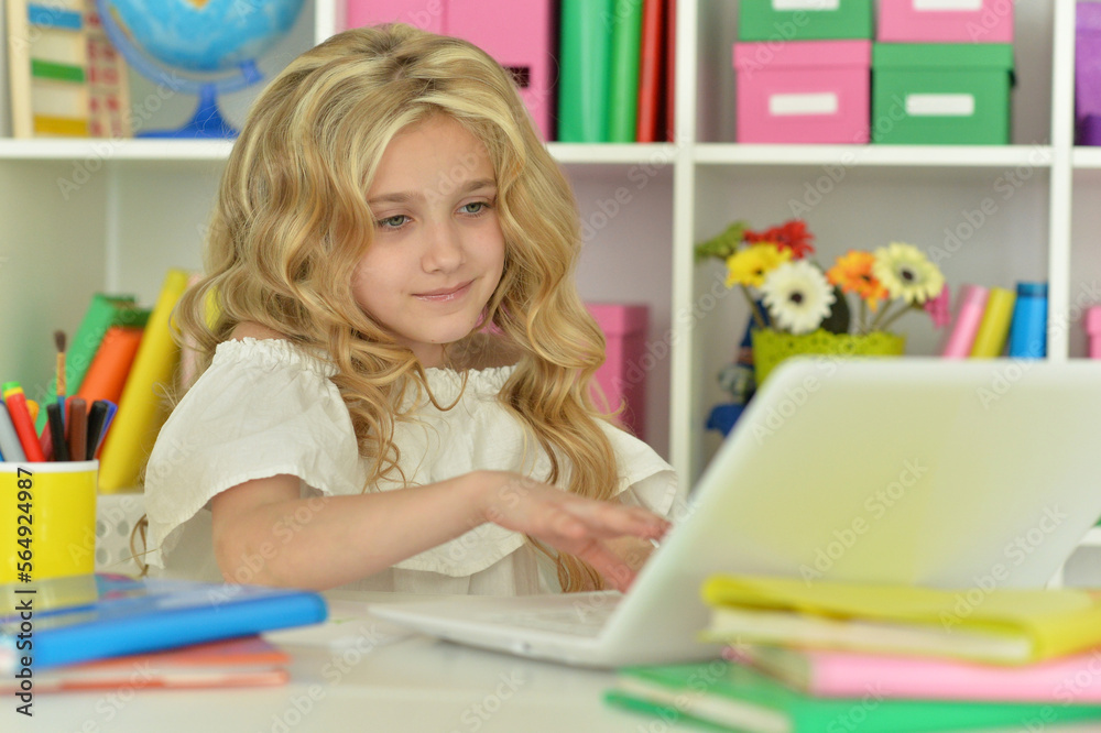 girl using laptop at desk at home girl using laptop at desk at home