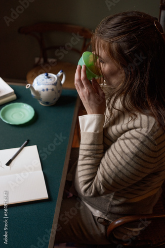 Creative woman working from home drinking tea photo