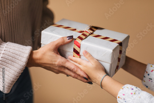 Woman Giving Christmas Present to Little Girl  photo