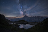 Milky way over mountain range near alpine lake