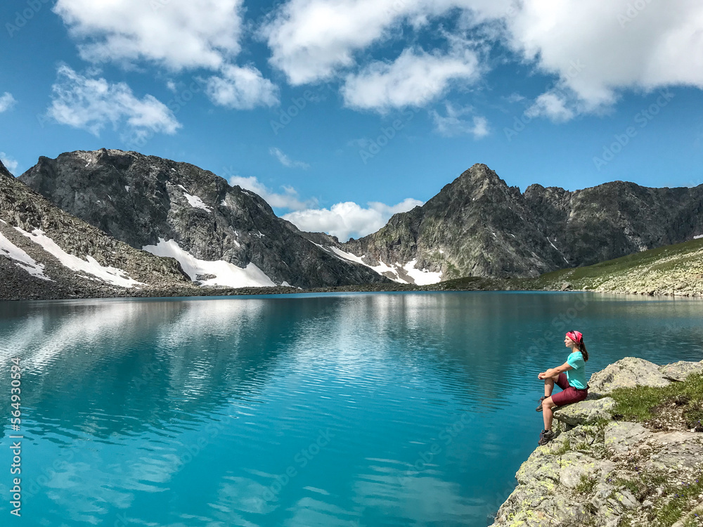 The girl in turquoise lake in mountains The girl in turquoise lake in mountains