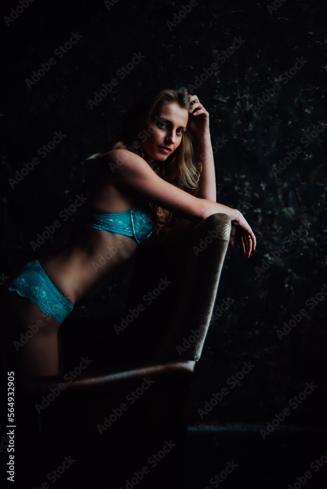 Fototapeta premium tanned girl in blue lingerie. beautiful figure