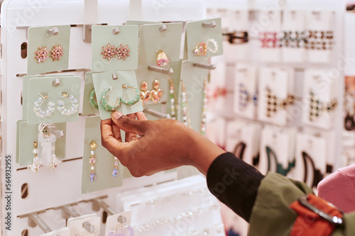 Woman looking at earrings in a store
